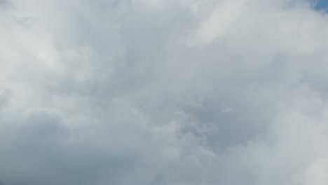 expansive timelapse of dynamic clouds moving quickly on a sunny day, sky fills the frame