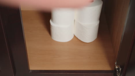 man stockpiles toilet paper, white american hoarding toilet tissue, toilet paper stash, man hides toilet paper in preparation for coronavirus covid-19