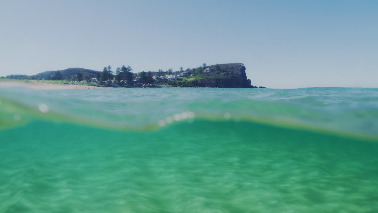 Slow-motion underwater view of ocean waves in Sydney, Australia, capturing the swirling water and bubbles