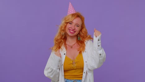 Redhead-girl-in-festive-hat-shouting-raising-fists-in-gesture-I-did-it-celebrating-success,-winning