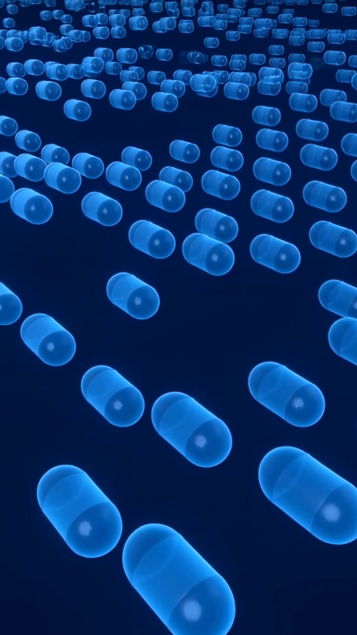 Video verticale: Telecamera in movimento che rivela capsule blu luminose che si muovono verso l'obiettivo in un vuoto blu scuro, creando profondità.