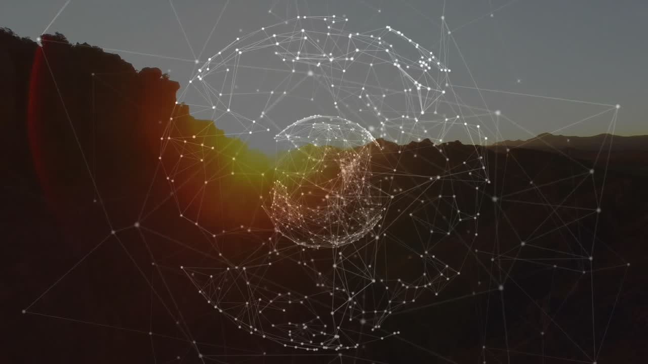 Abstract digital network sphere floating over sunset canyon, showing translucent wireframe spheres
