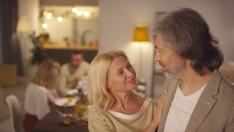 couple hugging on thanksgiving, looking at the camera