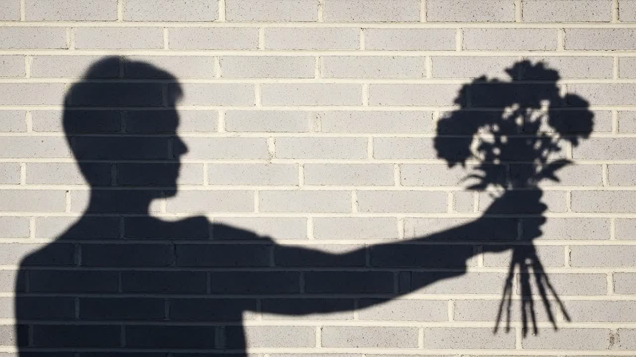 A Beautiful Shadow Play: The Silhouette of a Person Holding a Bouquet of Flowers Against a Textured Wall