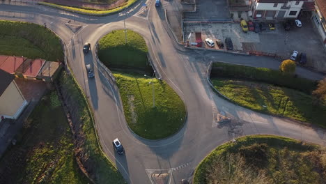 vehicles circling around the small double roundabout with a water channel