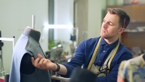 male designer of men's suits is thinking about his new product
