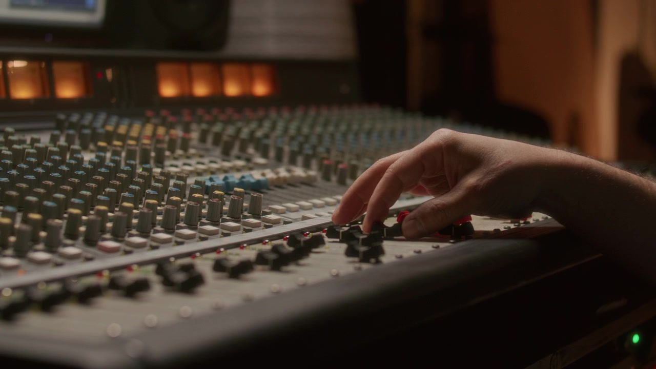 Close Up of Adjusting Sliders on Mixing Console during Recording Session