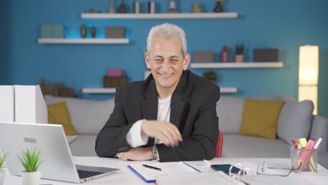 Home-office-worker-man-waving-at-camera.