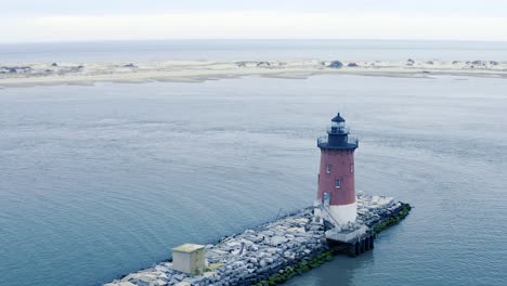 Old-Red-Breakwater-Light-House-Cape-Henlopen-Delaware-Bay-United-States-and-Atlantic-Ocean-on-Overcast-Spring-Day-Aerial-Reveal