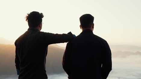 cinematic shot of two friends watching sunrise view.