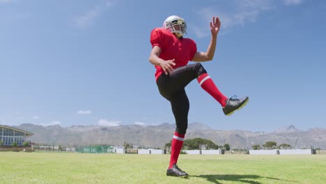 american football player kicking a ball