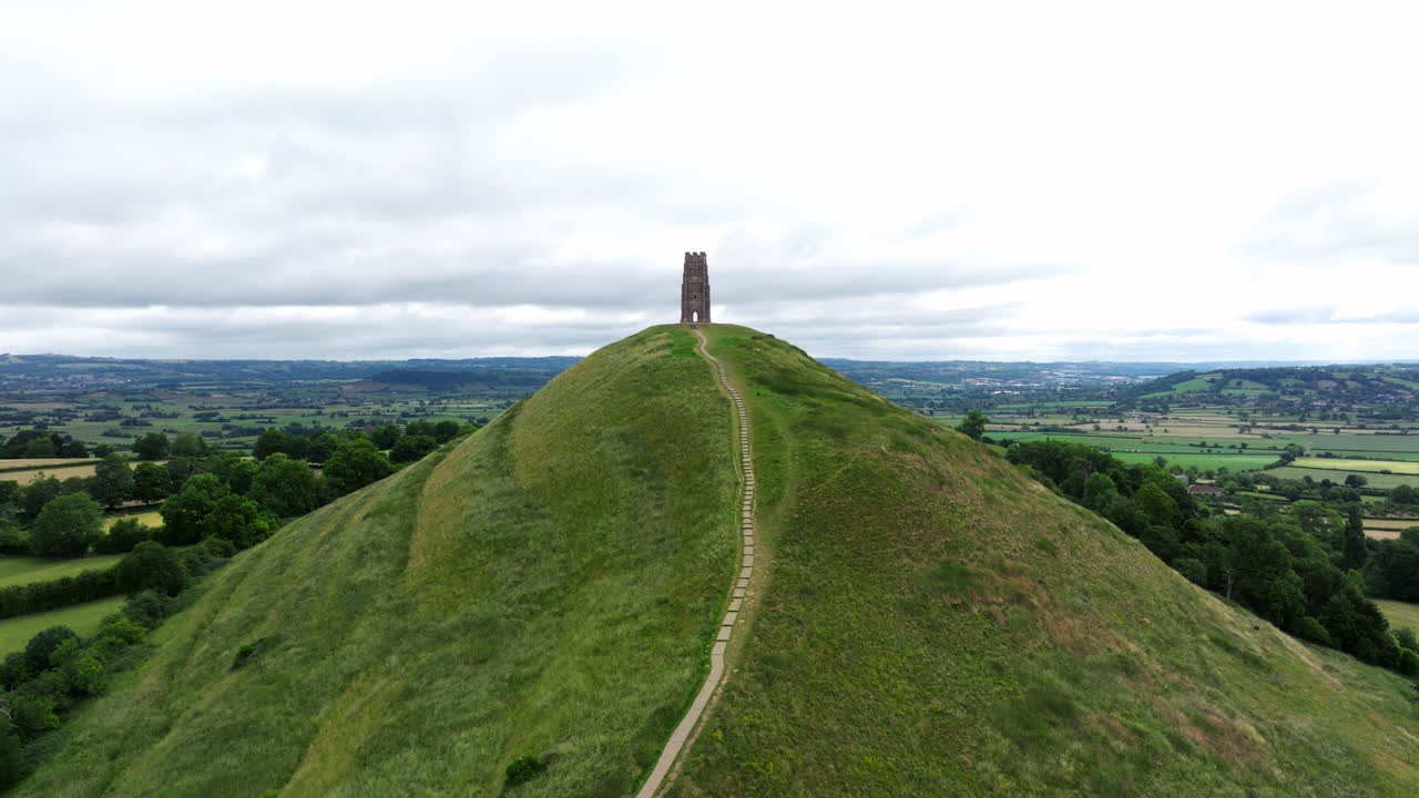 Glastonbury Tor Mountain Peak With The Church Ruins In Glastonbury, United Kingdom. Aerial Drone Shot