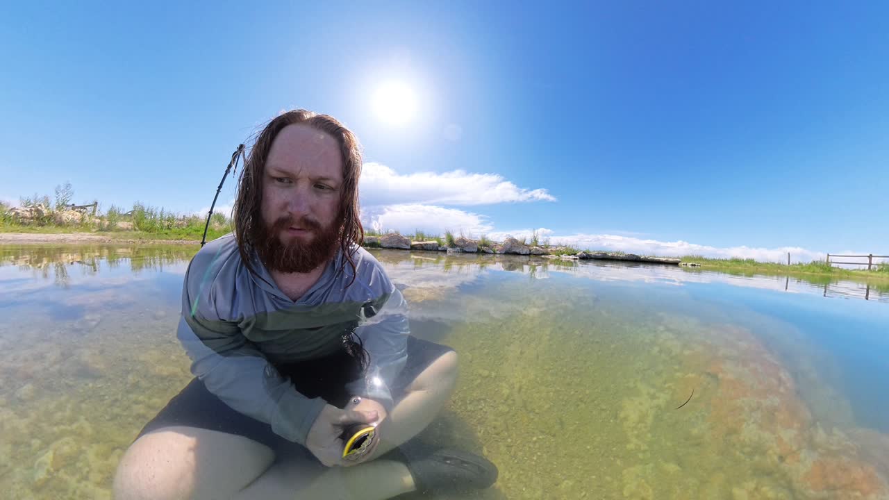 Hot Spring in Utah with a red haired male observing fish swimming