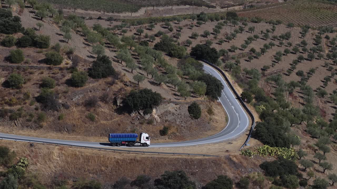 Blue truck driving around the corner