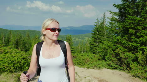 caucasian middle-aged woman climbs a mountain active and healthy lifestyle steadicam shot