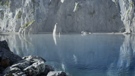 sand beach among rocks at atlantic ocean coast in portugal