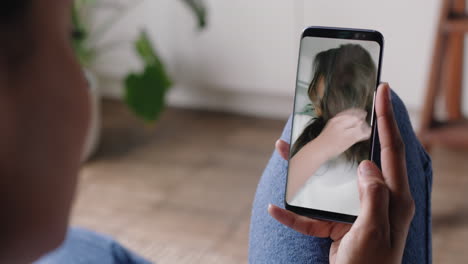 young-woman-having-video-chat-using-smartphone-at-home-chatting-to-friend-showing-off-hairstyle-sharing-lifestyle-enjoying-online-communication