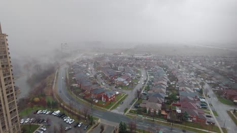 Wide-shot-of-foggy-city-high-angle-over-houses