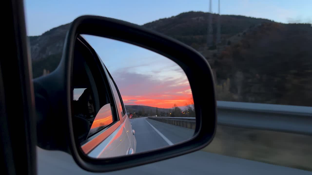 Golden orange twilight in a car mirror road trip in sunset time turkey natural landscape nature view tourism destination travel in highway road to Istanbul Amasya Cappadocia mountain skyline evening