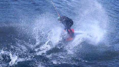 Extreme-man-studying-riding-wakeboarding-stunt-on-water