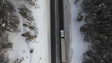 Aerial-top-down-shot-of-cars-driving-down-a-road-in-the-Colorado-Rockies