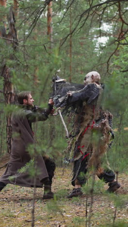 hombre armado lucha contra el ataque de la bestia aterradora en el bosque de pinos en cámara lenta. los participantes del club de cosplayers se divierten. batalla sangrienta en el bosque