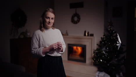 Portrait-Of-Positive-Woman-Standing-By-The-Fireplace-In-Livingroom-At-Home