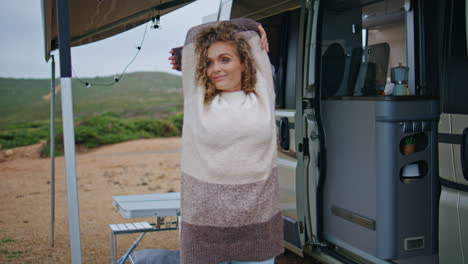 joyful woman relaxing campsite stretching body outdoors early morning closeup.