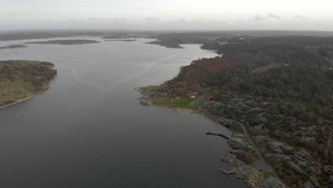 Aerial-rising-and-flying-backwards-over-coastal-landscape