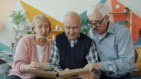three seniors reminisce over old photos