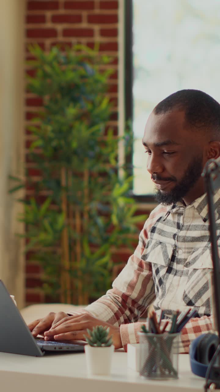 Vertical video: Office manager working from home with laptop