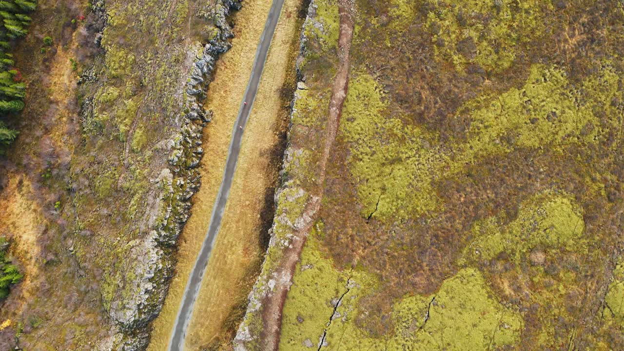 Top down aerial of Langist&iacute;gur canyon with a hiking trail in Thingvellir National Park in Iceland