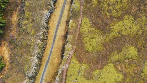 Top-down-aerial-of-Langistígur-canyon-with-a-hiking-trail-in-Thingvellir-National-Park-in-Iceland