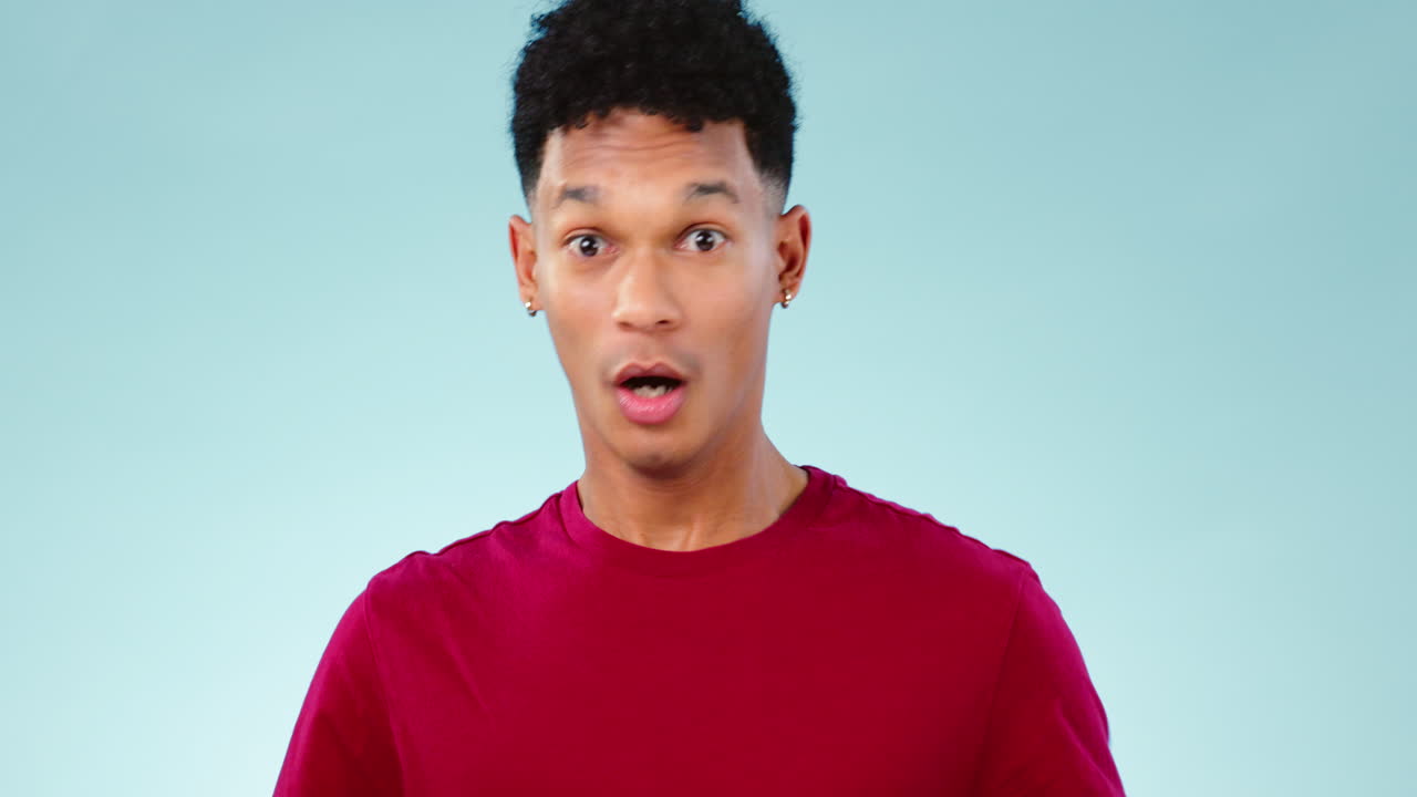 Stop, hands and face of man in studio with anxiety
