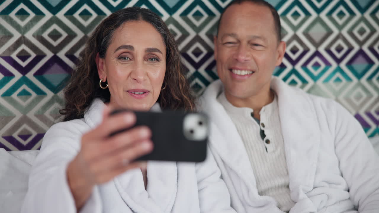 Couple making a video call in bed