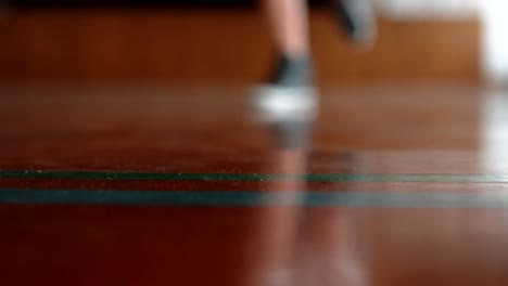 feet of schoolboy running on basketball court