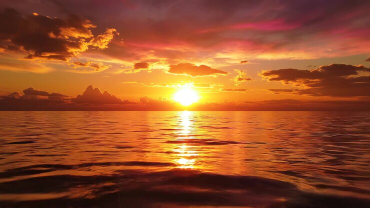 Stunning golden sunset reflecting on calm ocean water