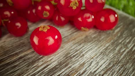 super close macro of a redcurrants on a wooden table.