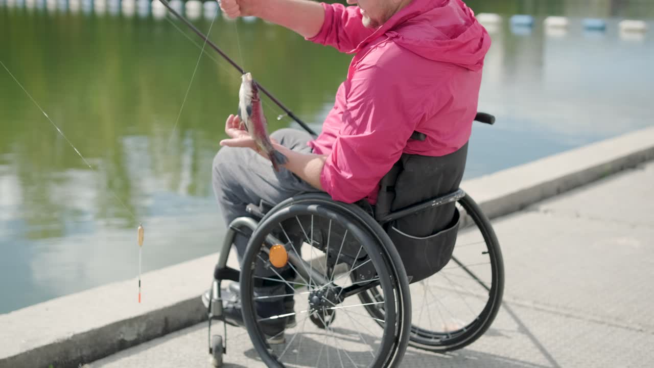 persona con discapacidad física que utiliza silla de ruedas para pescar en el muelle de pesca