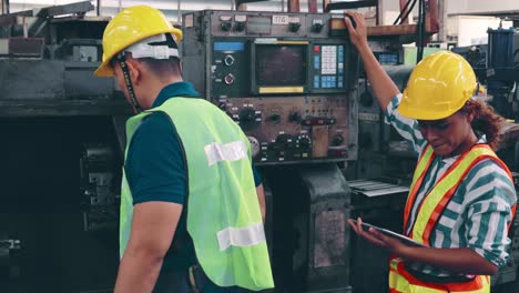 Group-of-factory-workers-using-machine-equipment-in-factory-workshop