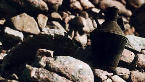 old metal jug at rocks