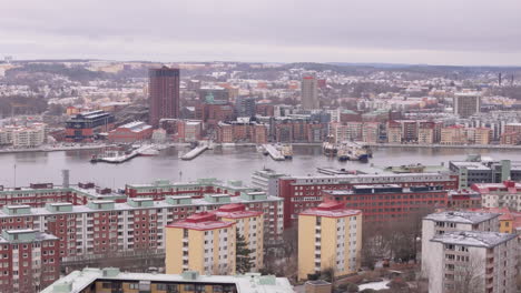 Trucking-aerial-winter-cityscape-view-over-Gota-alv-river-in-Gothenburg,-Sweden