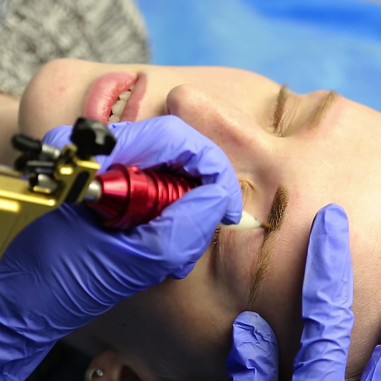 Tattooist making permanent make-up