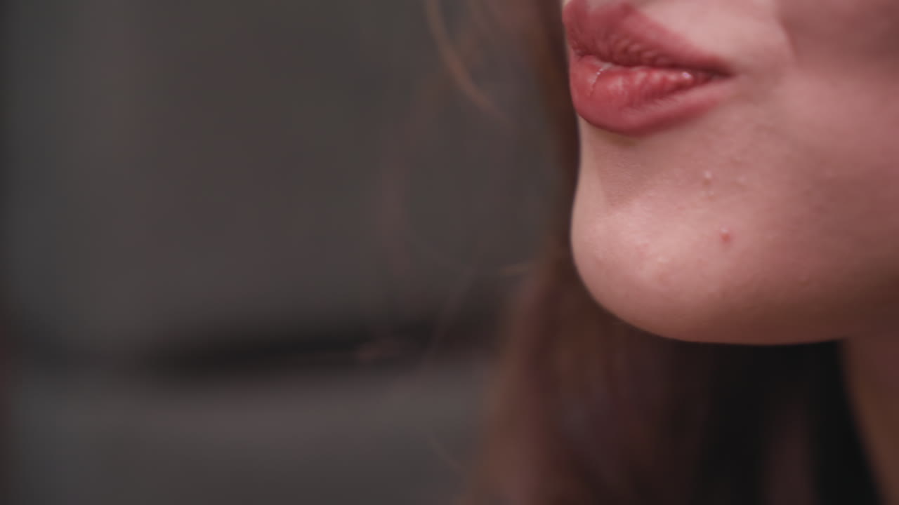Extreme closeup of lady taking bite of creamy strawberry dessert using fork, lips slightly parted as she enjoys indulgent treat, emphasizing sensuality and flavor in slow, intimate food moment
