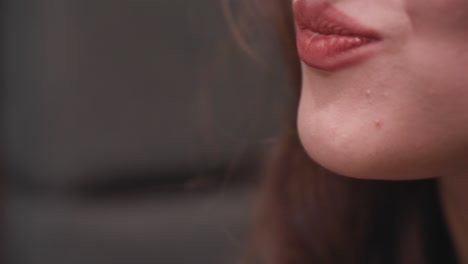 extreme closeup of lady taking bite of creamy strawberry dessert using fork, lips slightly parted as she enjoys indulgent treat, emphasizing sensuality and flavor in slow, intimate food moment