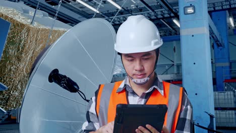 satellite technician inspecting equipment