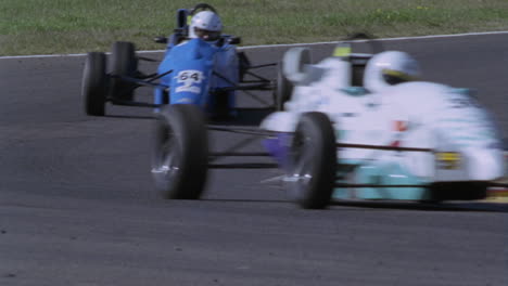 formula cars compete on a circuit track 2