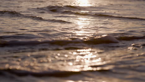 Sea-waves-rushing-at-the-beach-during-sunset