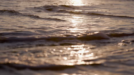 sea waves rushing at the beach during sunset