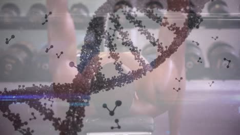 animation of dna strand spinning and data processing over strong man exercising